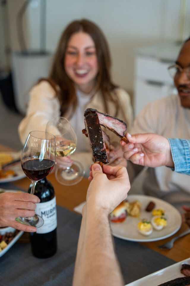 Cheers with wine and spare ribs