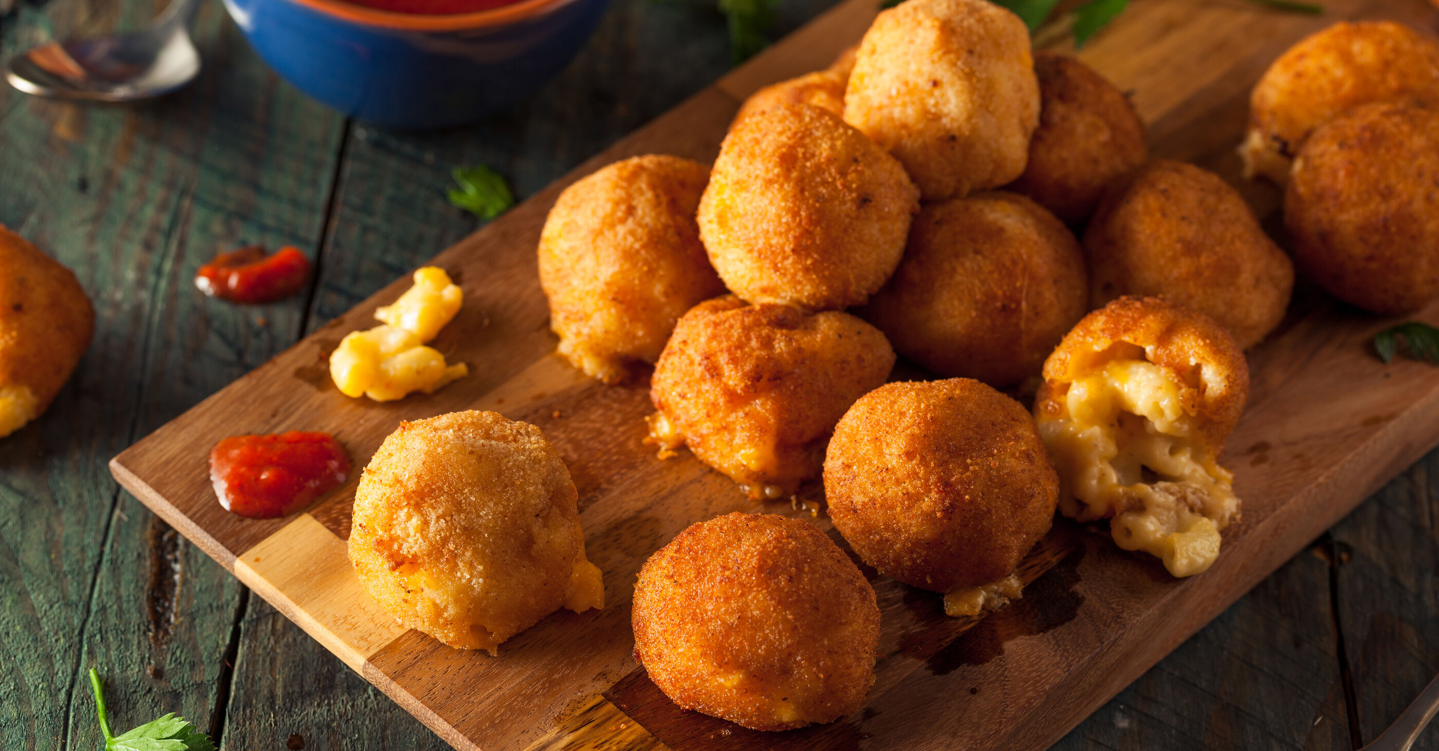 Mac and Cheese Bites with Sriracha Aioli on wood board Mac and Cheese Bites with Sriracha Aioli on wood board